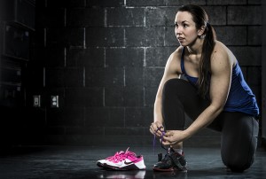 woman tying gym shoe