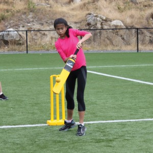 girl playing cricket